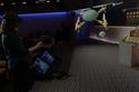 In this demo of Windows Holographic and the HoloLens headset, the user picks elements from a 3D "toolbox" to make a 3D flying robot, all in the air in front of her. 