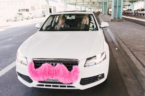 A Lyft car sporting its standard pink mustache.