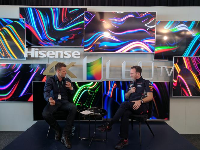 Former Gelong AFL star Lee Colber interviews Red Bull Racing Formula 1 boss, Christian Horner at the Melbourne 2017 Grand Prix while sitting in front of Hisense ULED TVs and launching the new Series 8 and Series 9 Hisense TVs.