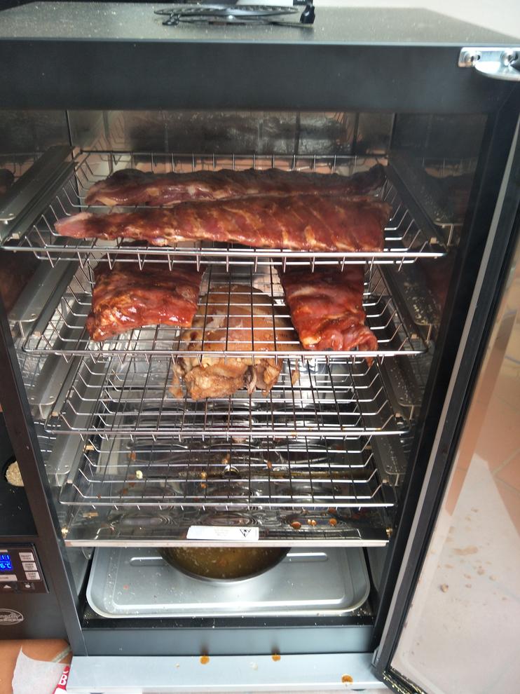 Pork ribs and shoulder hit the oven. Note the water bowl at the bottom.